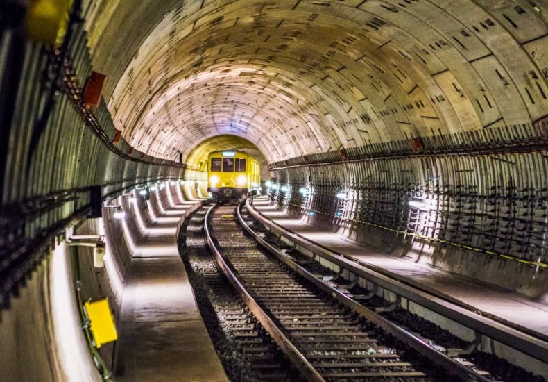 Dramatic view of a Berlin subway tunnel with train approaching, showcasing modern infrastructure.